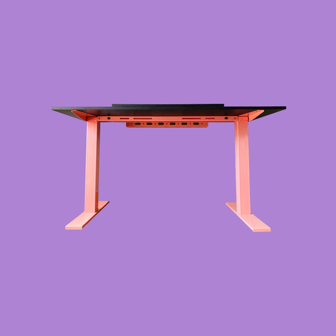 Underneath view of a black desk with a pink desk frame.