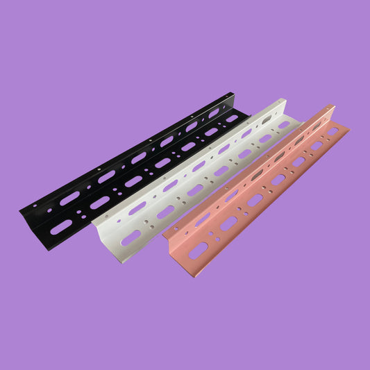 A collection of cable trays in matte black, matte white and pink.